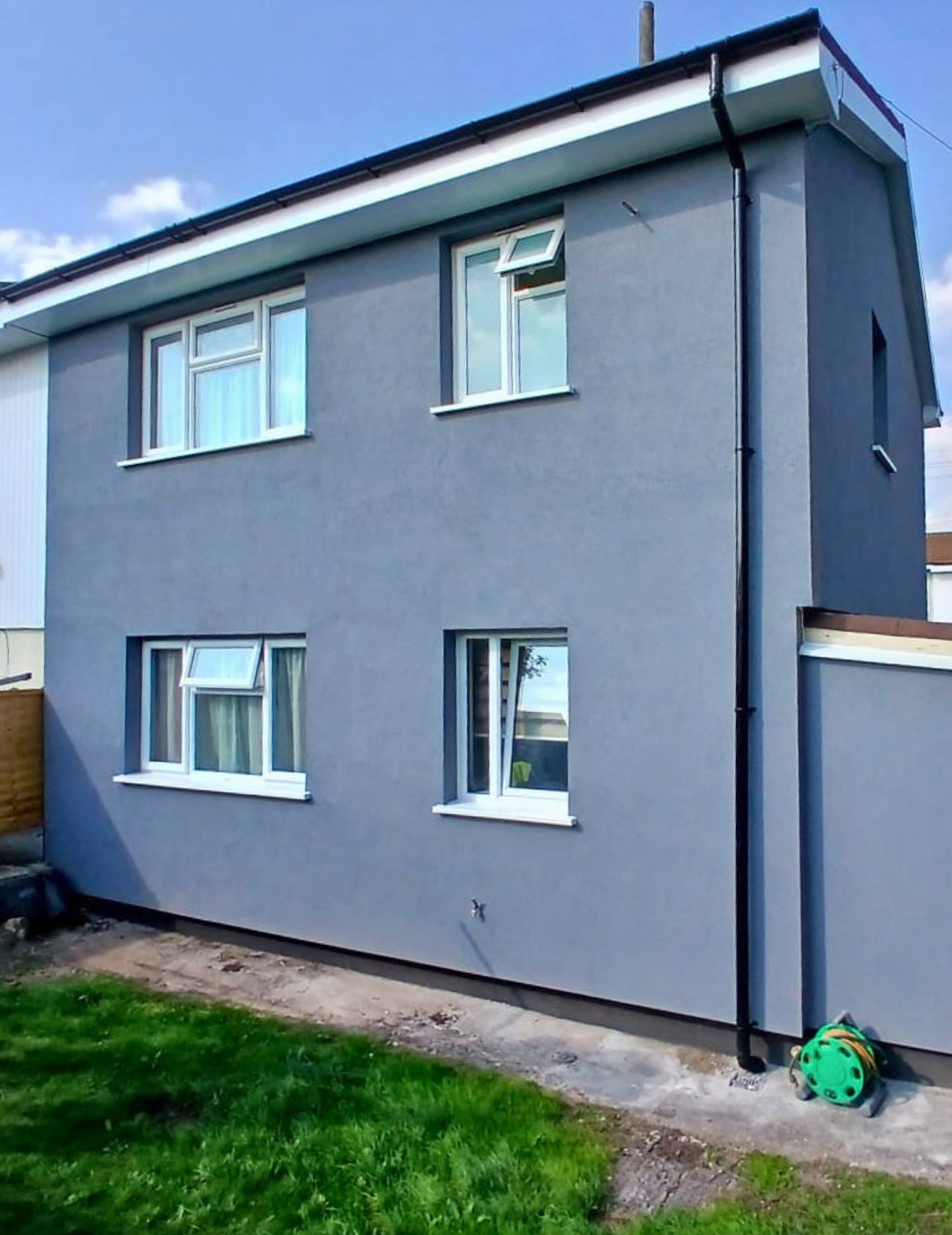 Modernised home in Leamington Spa with smooth grey silicone render and clean black guttering details.