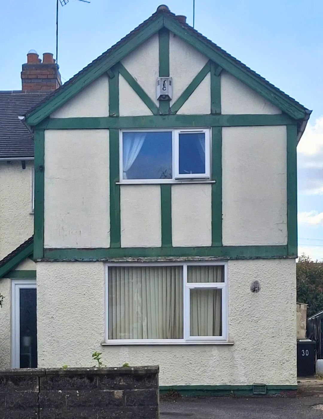 Mock-Tudor semi-detached gable in Derby with dated green timber detailing before render by PD Rendering