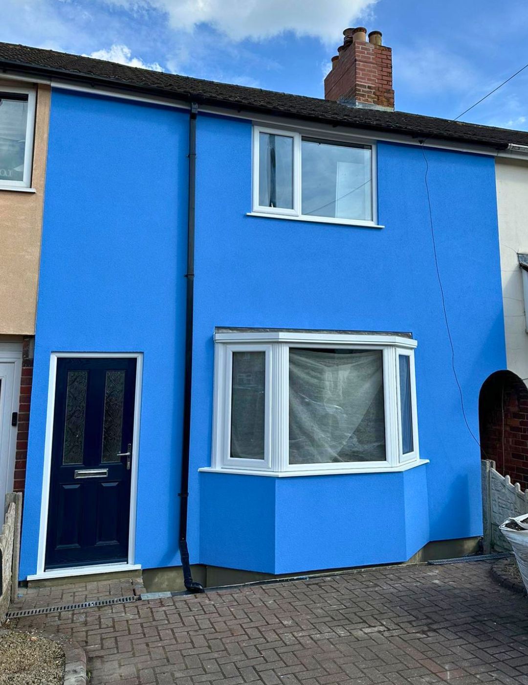 Midlands terraced property with vibrant custom blue silicone render finish applied by PD Rendering