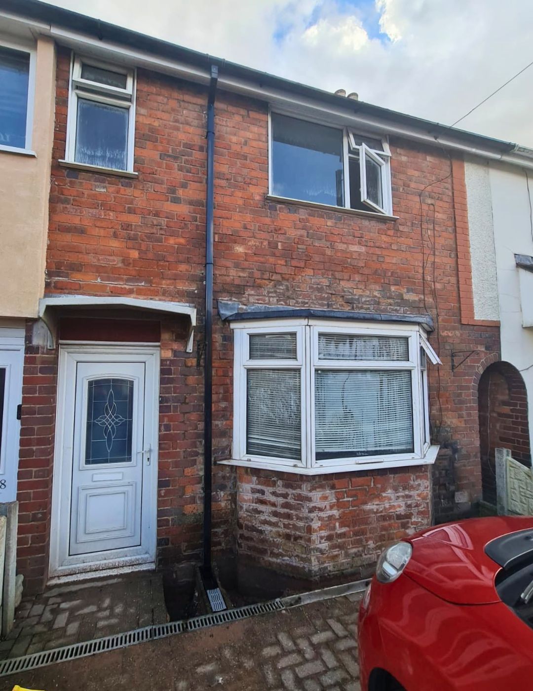 Midlands terraced house with unrendered exposed brick facade before PD Rendering silicone application