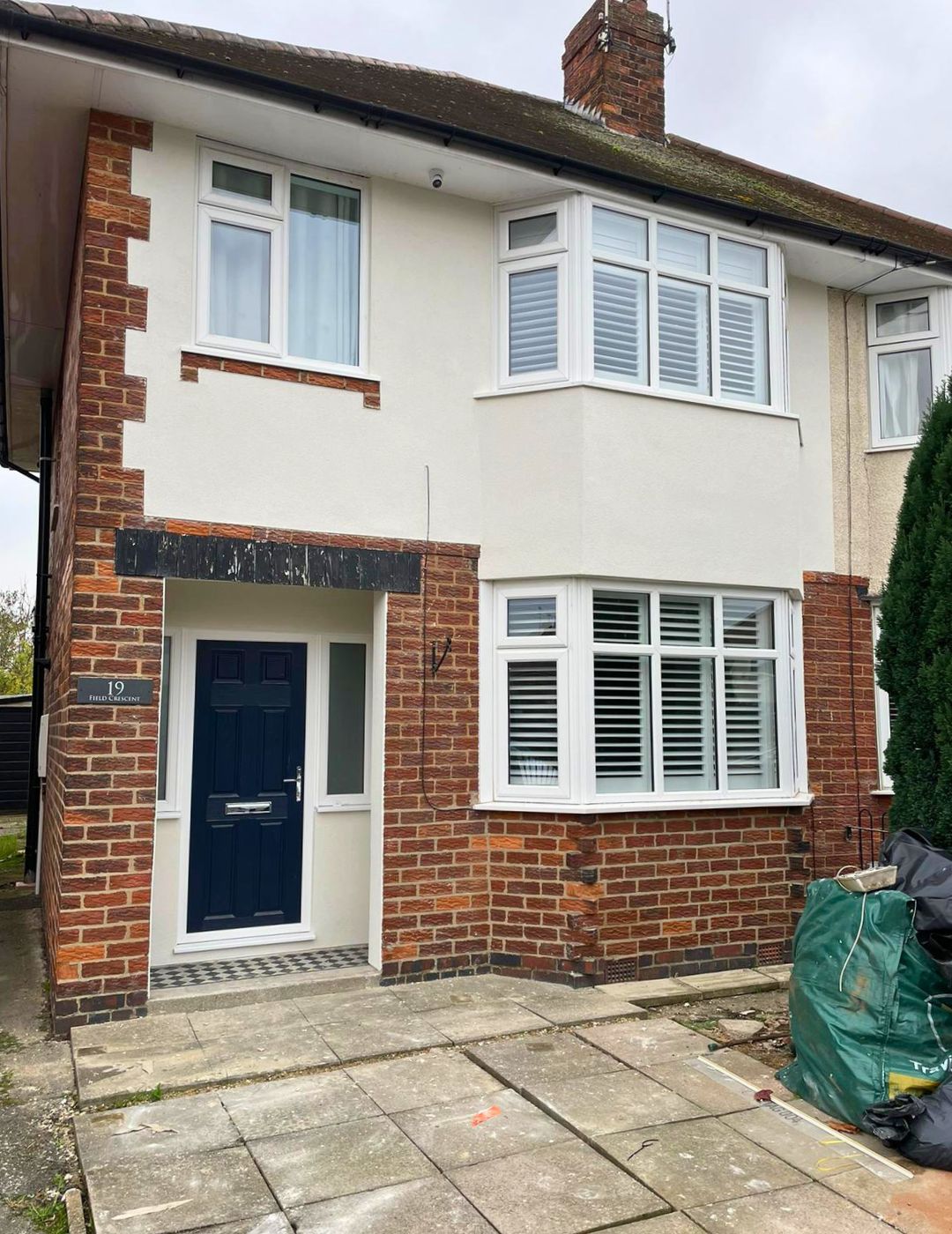Northampton semi-detached with fresh white silicone render and exposed brick accent details by PD Rendering
