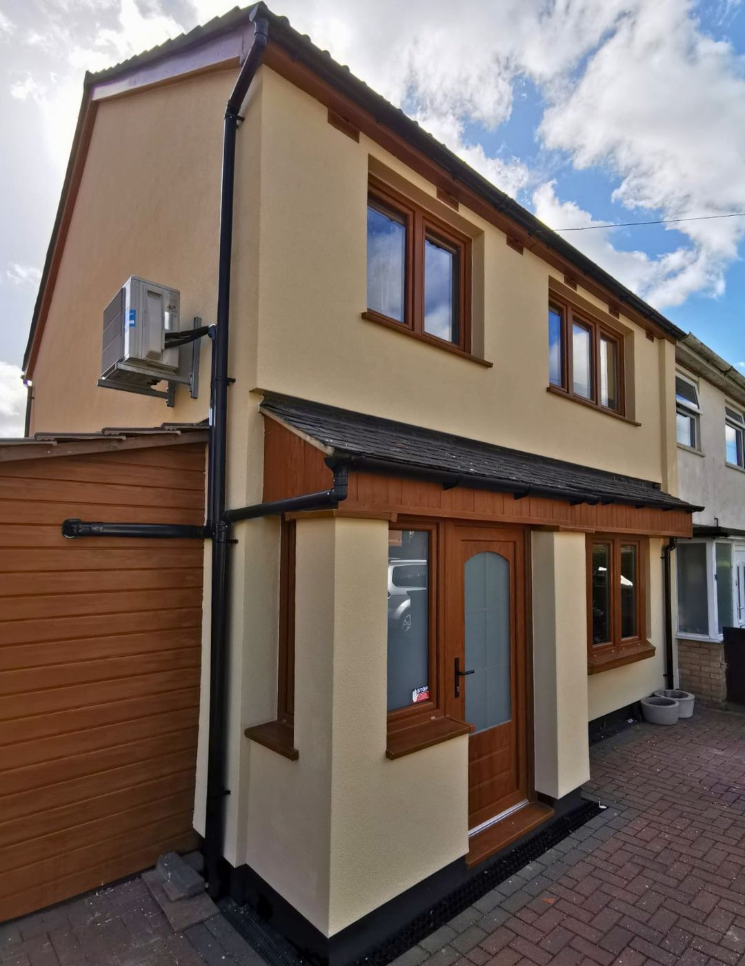 Wellingborough home transformed with warm cream silicone render and golden oak detailing by PD Rendering