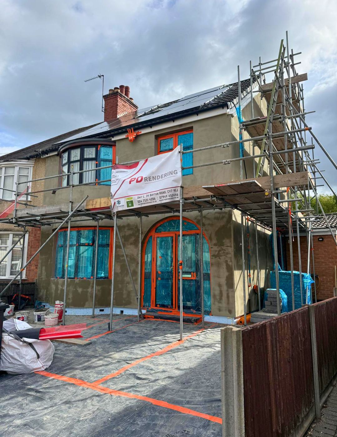 Semi-detached home in Worcester during render works with PD Rendering scaffold and basecoat applied