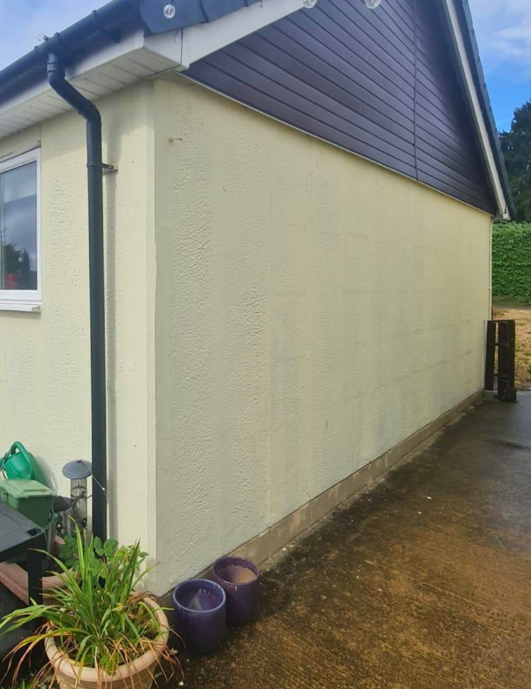 Stained and faded external walls of a London semi-detached property before professional rendering service.