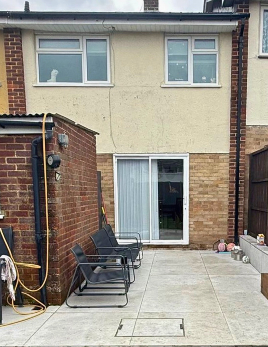 London terraced house facade showing degraded render and aged brickwork before PD Rendering works.